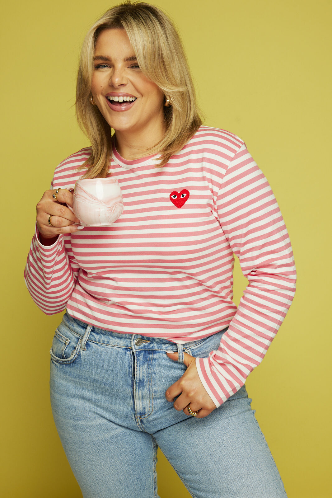 Emma smiling, holding a mug