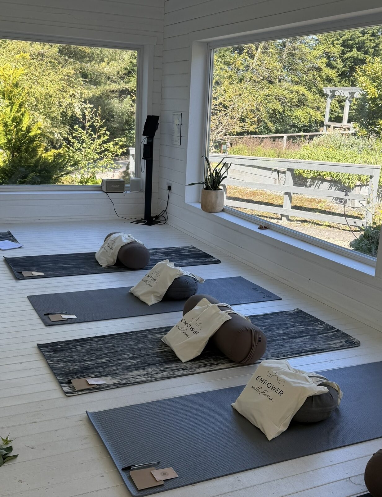 Empty retreat studio set up with mats and blankets, morning light